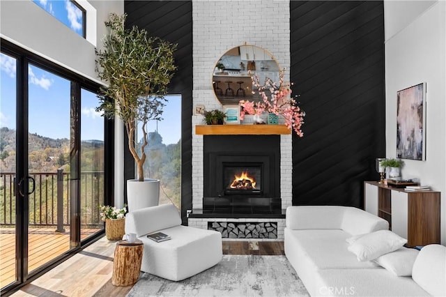 791 Cypress Rd, Lake Arrowhead, CA 92321 - sitting room with a high ceiling, wood finished floors, and a fireplace