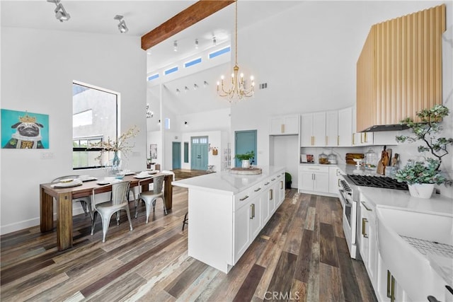 791 Cypress Rd, Lake Arrowhead, CA 92321 - kitchen featuring gas range, high vaulted ceiling, a chandelier, dark wood-type flooring, and pendant lighting