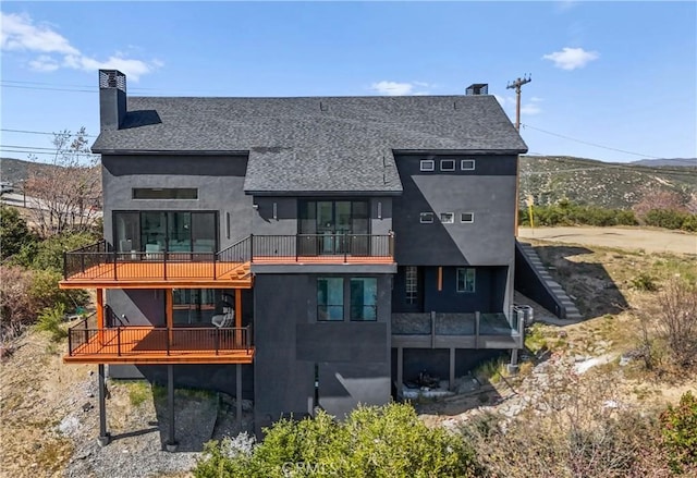 791 Cypress Rd, Lake Arrowhead, CA 92321 - rear view of property featuring a balcony, a chimney, roof with shingles, stucco siding, and a mountain view