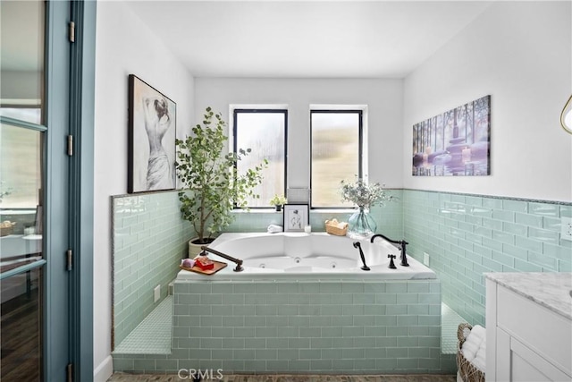 791 Cypress Rd, Lake Arrowhead, CA 92321 - bathroom featuring a tub with jets, vanity, a wainscoted wall, and tile walls