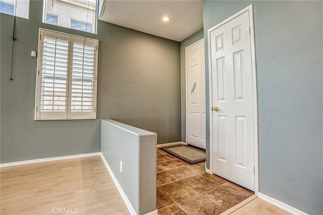 foyer entrance featuring baseboards and recessed lighting
