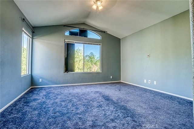 carpeted spare room with a ceiling fan, lofted ceiling, and baseboards
