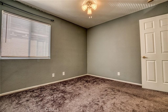 empty room featuring carpet flooring, ceiling fan, and baseboards
