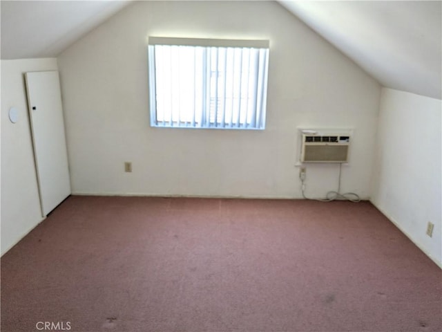 bonus room with carpet flooring, vaulted ceiling, and an AC wall unit