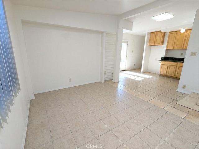 unfurnished living room featuring light tile patterned floors