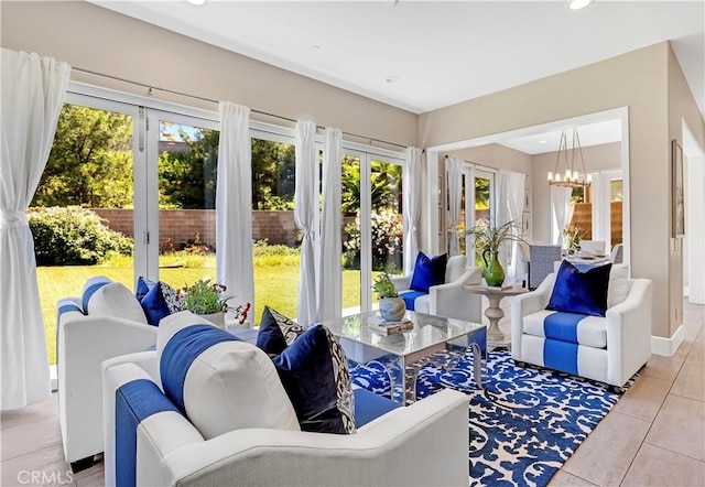 sunroom featuring a chandelier and french doors