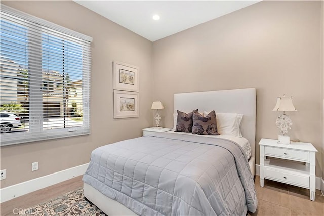 bedroom with baseboards, multiple windows, and recessed lighting