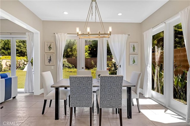 tiled dining room with a chandelier