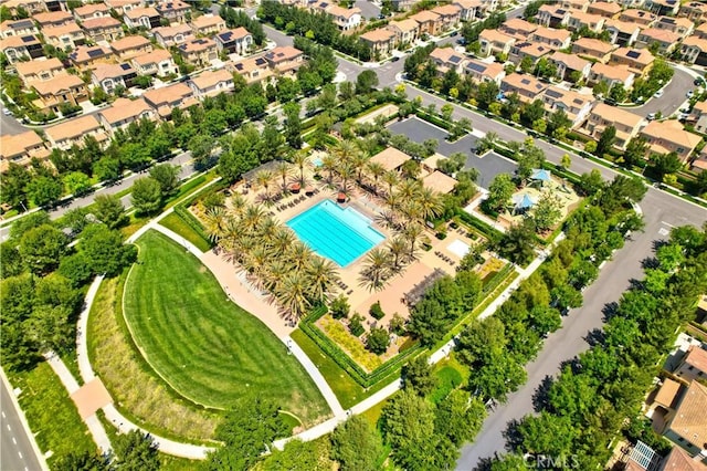 view of property location with a pool area and nearby suburban area