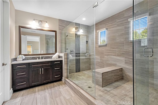 bathroom featuring a shower stall and vanity