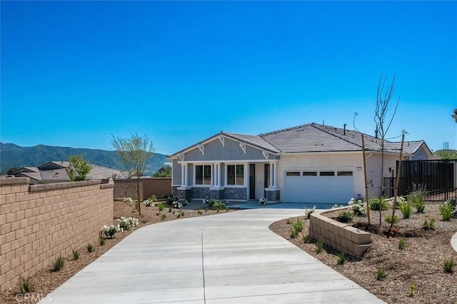 6533 Canyon Oaks Dr, Simi Valley, CA 93063 - view of front of property with fence, driveway, a garage, a mountain view, and stone siding