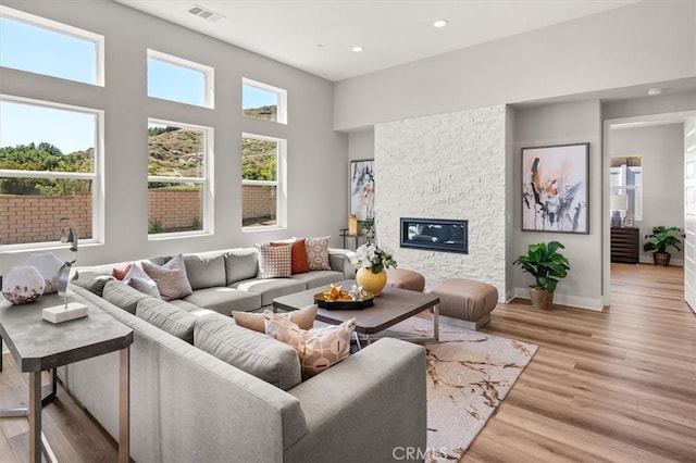 6533 Canyon Oaks Dr, Simi Valley, CA 93063 - living room featuring light wood-style flooring, recessed lighting, a stone fireplace, and baseboards