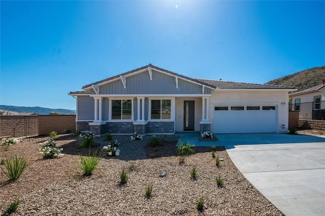 6533 Canyon Oaks Dr, Simi Valley, CA 93063 - view of front facade featuring fence, an attached garage, concrete driveway, and a mountain view