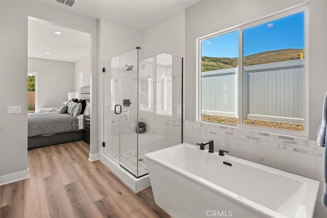 6533 Canyon Oaks Dr, Simi Valley, CA 93063 - full bathroom featuring ensuite bathroom, wood finished floors, a stall shower, a freestanding tub, and recessed lighting