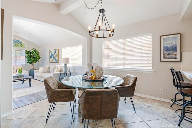 dining area featuring a chandelier, light tile patterned floors, and baseboards