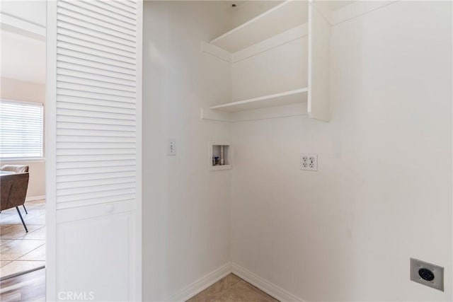 laundry area with hookup for an electric dryer, washer hookup, baseboards, and light tile patterned floors