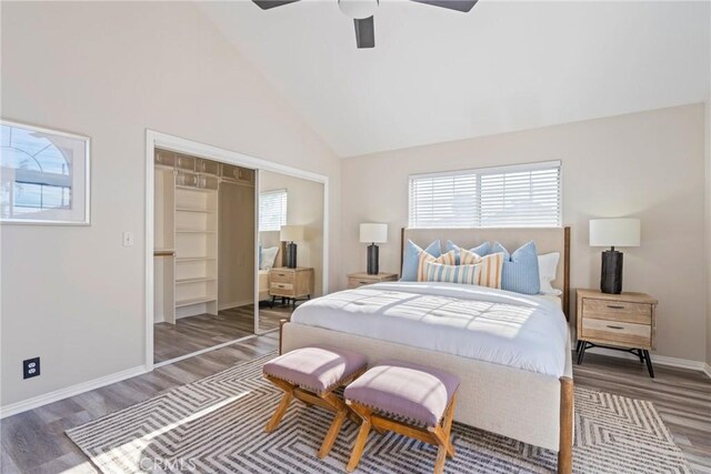 bedroom featuring wood finished floors, high vaulted ceiling, baseboards, a closet, and a ceiling fan