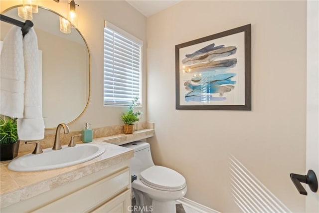 bathroom with toilet and vanity