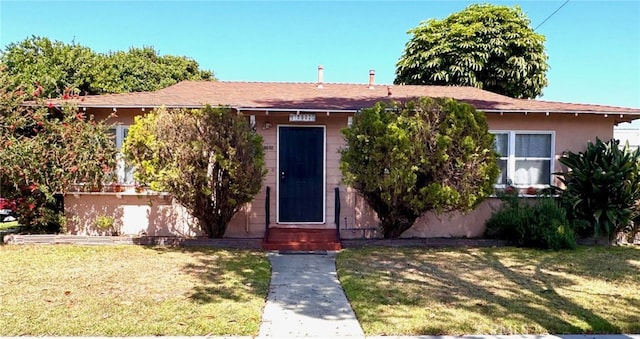 15602 Pitts Ave, Paramount, CA 90723 - view of property hidden behind natural elements featuring a front yard and entry steps