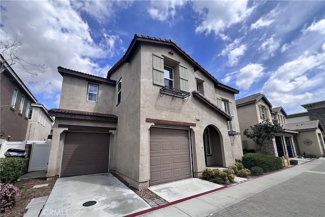 2873 S Via Belamaria, Ontario, CA 91762 - view of front of house with a garage, stucco siding, and concrete driveway