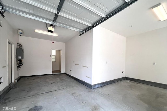 2873 S Via Belamaria, Ontario, CA 91762 - garage with a garage door opener, baseboards, and water heater