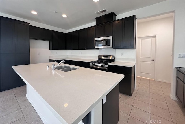 2873 S Via Belamaria, Ontario, CA 91762 - kitchen featuring stainless steel appliances, a sink, dark cabinets, light tile patterned flooring, and recessed lighting