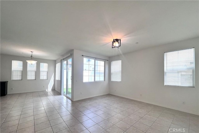 2873 S Via Belamaria, Ontario, CA 91762 - empty room featuring healthy amount of natural light, baseboards, and light tile patterned flooring