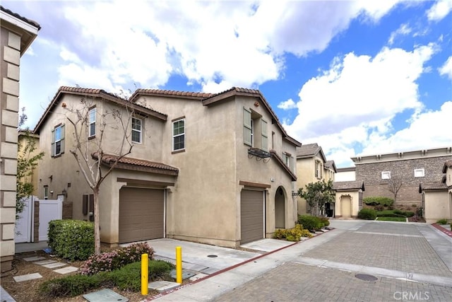 2873 S Via Belamaria, Ontario, CA 91762 - view of front facade featuring an attached garage, stucco siding, and a tiled roof