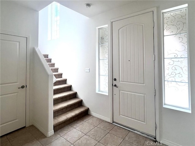 2873 S Via Belamaria, Ontario, CA 91762 - foyer entrance with stairs, baseboards, and light tile patterned flooring