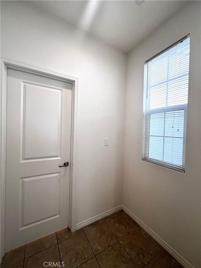 2873 S Via Belamaria, Ontario, CA 91762 - empty room with dark tile patterned flooring and baseboards