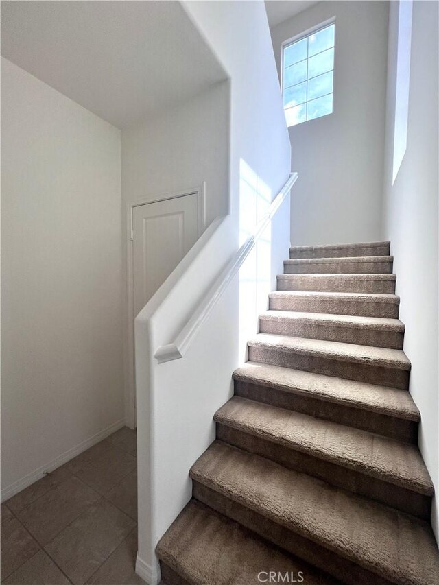 2873 S Via Belamaria, Ontario, CA 91762 - stairs featuring tile patterned flooring and baseboards