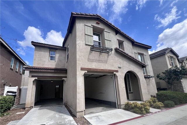 2873 S Via Belamaria, Ontario, CA 91762 - mediterranean / spanish house with an attached garage, stucco siding, concrete driveway, and a tile roof