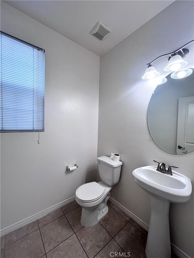 2873 S Via Belamaria, Ontario, CA 91762 - bathroom featuring tile patterned flooring, toilet, baseboards, and a sink