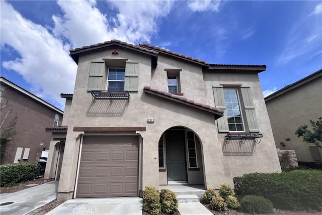 2873 S Via Belamaria, Ontario, CA 91762 - view of front of property with an attached garage, a tiled roof, and stucco siding