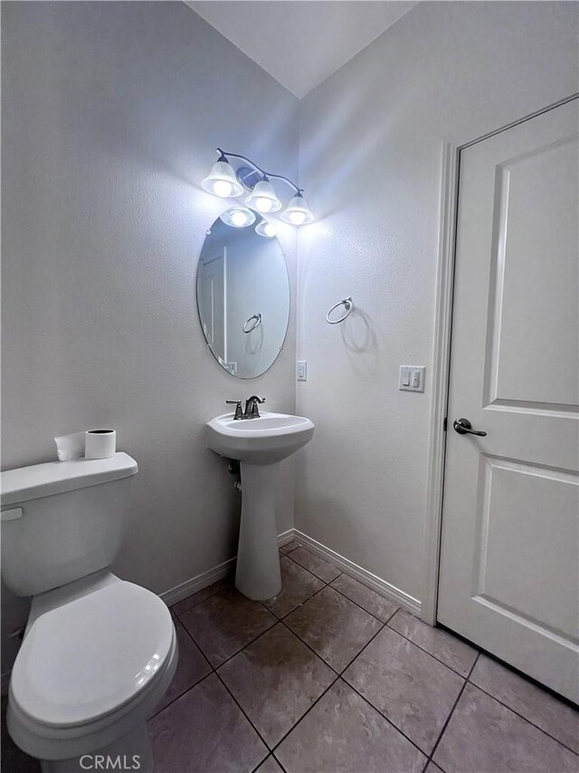 2873 S Via Belamaria, Ontario, CA 91762 - half bath with tile patterned flooring, baseboards, toilet, and a sink