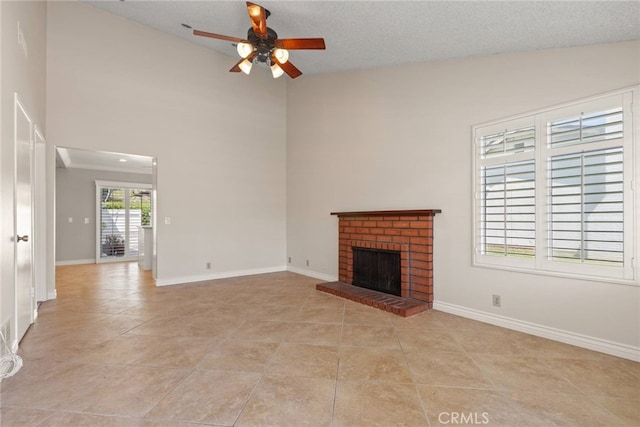 20081 Winfield Ct Unit 2, Yorba Linda, CA 92886 - unfurnished living room with ceiling fan, a fireplace, light tile patterned floors, baseboards, and a high ceiling