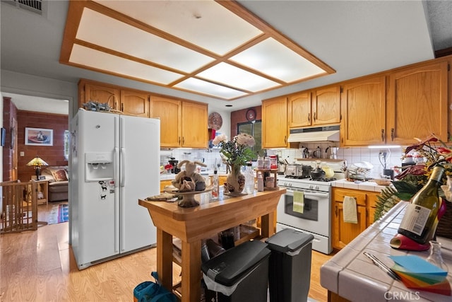 32923 Tindall Ave, Acton, CA 93510 - kitchen with white appliances, tile counters, under cabinet range hood, and tasteful backsplash