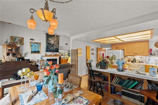 32923 Tindall Ave, Acton, CA 93510 - dining room featuring a textured ceiling and light wood-type flooring