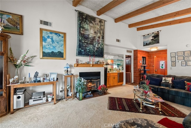 32923 Tindall Ave, Acton, CA 93510 - living room with carpet, a fireplace with flush hearth, beamed ceiling, and a towering ceiling