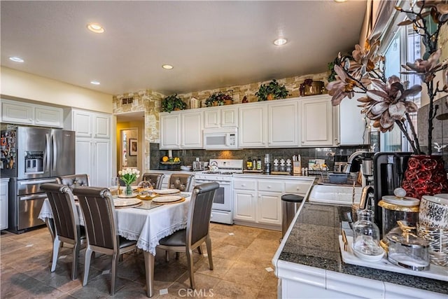 15108 Lighthouse Ln, Lake Elsinore, CA 92530 - kitchen with white appliances, a sink, decorative backsplash, white cabinetry, and recessed lighting