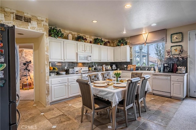 15108 Lighthouse Ln, Lake Elsinore, CA 92530 - kitchen featuring white appliances, recessed lighting, white cabinets, tasteful backsplash, and a sink