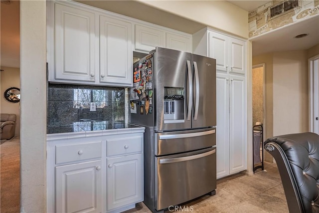 15108 Lighthouse Ln, Lake Elsinore, CA 92530 - kitchen with stainless steel refrigerator with ice dispenser, white cabinets, tile counters, and light tile patterned floors