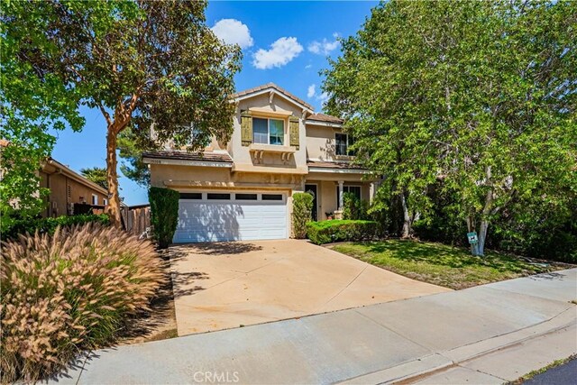 15108 Lighthouse Ln, Lake Elsinore, CA 92530 - view of front of home with an attached garage, concrete driveway, and stucco siding