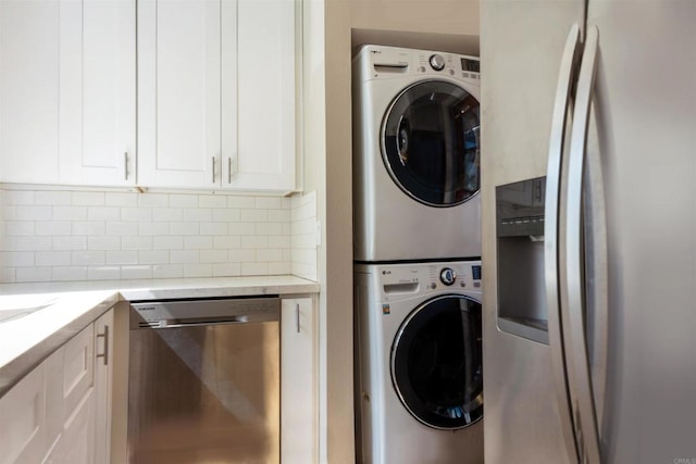 clothes washing area featuring estacked washer and dryer
