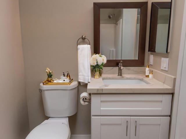 bathroom featuring toilet and vanity