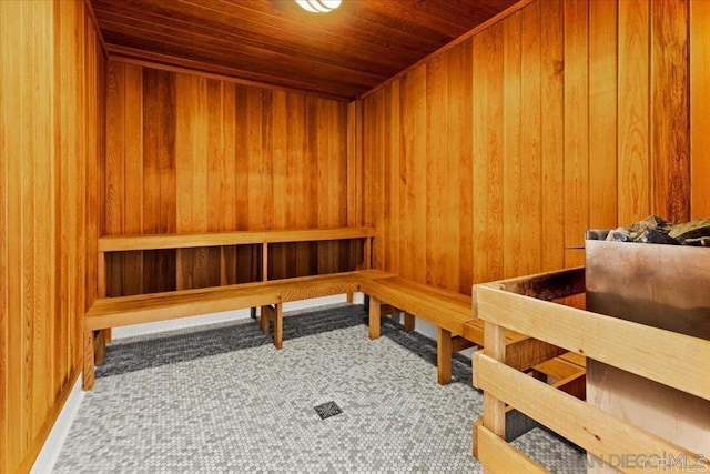 sauna featuring wooden ceiling, wood walls, and carpet floors