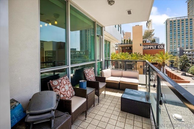 balcony with an outdoor living space and a city view