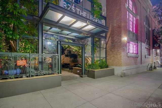 property entrance featuring brick siding