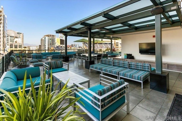 view of patio with outdoor lounge area and a view of city