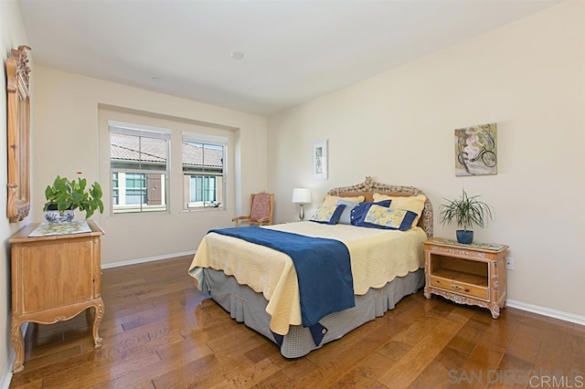 bedroom featuring wood-type flooring and baseboards
